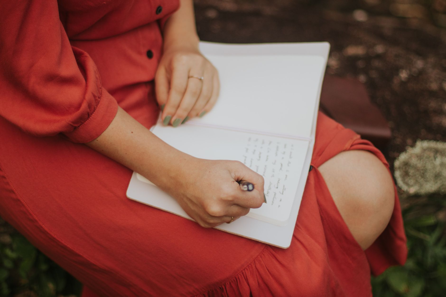 Travel journalist writing field notes in nature
